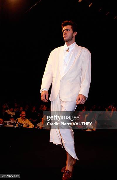 French designer Jean-Paul Gaultier shows his 1985 spring-summer men's ready-to-wear line in Paris. The model is wearing a white tuxedo jacket.