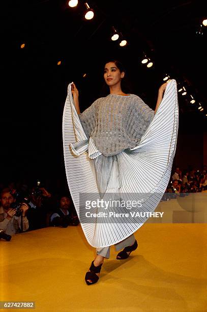 Japanese designer Issey Miyake shows his 1985 spring-summer women's ready-to-wear line in Paris. The model is wearing a pleated skirt with a loose...