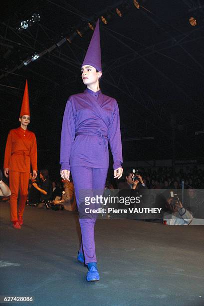 Japanese design house Kenzo shows its 1985-1986 fall-winter women's ready-to-wear line in Paris. The model is wearing a purple pants outfit and a...
