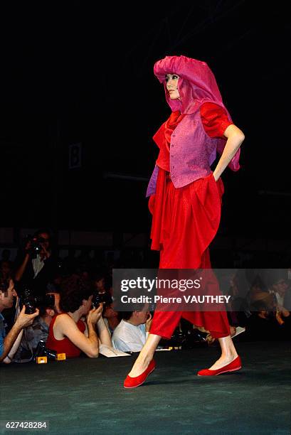 Japanese design house Kenzo shows its 1986 spring-summer women's ready-to-wear line in Paris. The model is wearing a bright red pants outfit with a...