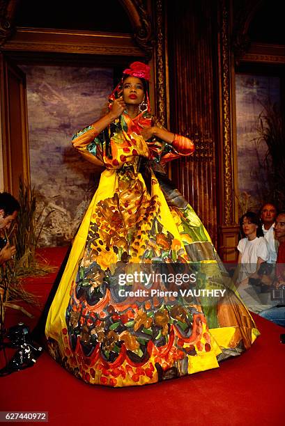 Fashion model wears the latest haute couture fashions by French designer Christian Lacroix at his 1987-1988 Fall-Winter fashion show in Paris. She...