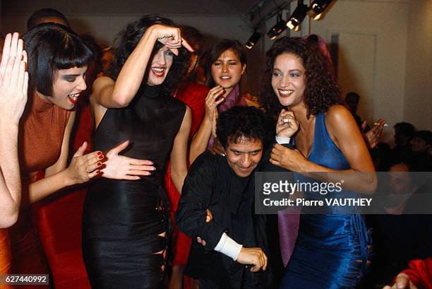 Tunisian designer Azzedine Alaia is surrounded by his models at his 1986 spring-summer women's fashion show in Paris.