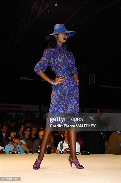 French designer Yves Saint Laurent shows his 1986 spring-summer women's ready-to-wear line in Paris. Model Iman is wearing a blue floral dress with a...