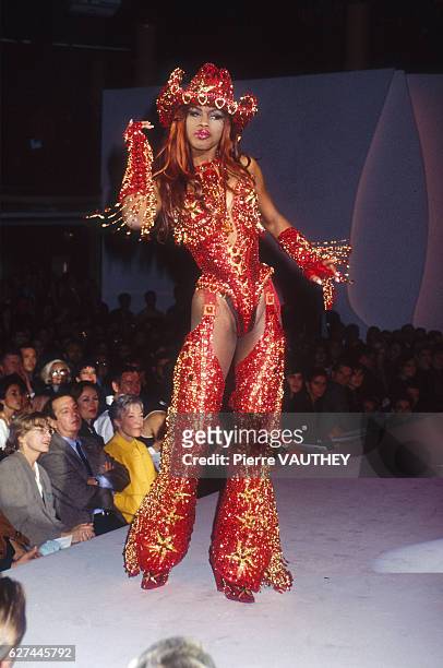 Fashion model wears a women's ready-to-wear glittery red cowgirl outfit with chaps and a cowboy hat by German fashion designer Thierry Mugler at his...