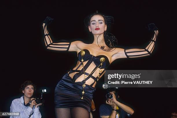 Fashion model wearing a ready-to-wear corset with bustier by French fashion designer Jean Paul Gaultier. She is modeling the outfit during his...