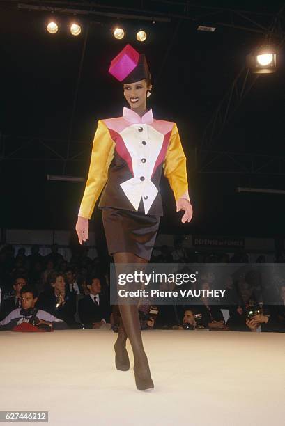 Fashion model Iman wears a multicolored ready-to-wear suit by French fashion designer Yves Saint Laurent. She is modeling the suit during his...