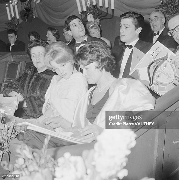 Austrian actress Romy Schneider attends the opening night of a play with her mother, stage and film actress Magda Schneider. Directly behind them is...