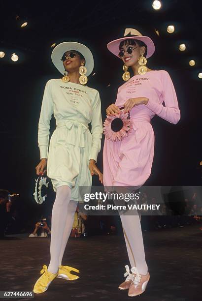 Two fashion models wear pastel ready-to-wear dresses by French fashion designer Sonia Rykiel. They are modeling the dresses during her Spring-Summer...