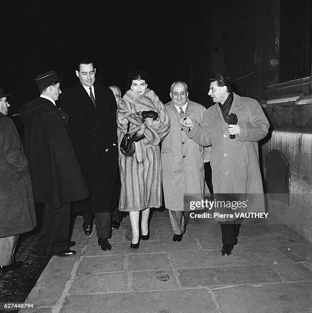 Opera singer Maria Callas walks down a Paris sidewalk with her husband, Italian industrialist Giovanni Battista Meneghini and friends.