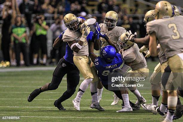 Safety D.J. Hampton of the Idaho Vandals strips the ball away from wide receiver Chancellor Triplett of the Georgia State Panthers during first half...