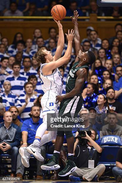 Luke Kennard of the Duke Blue Devils puts up a shot against Eron Harris of the Michigan State Spartans at Cameron Indoor Stadium on November 29, 2016...