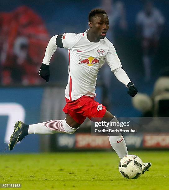 Naby Keita of RB Leipzig runs with the ball during the Bundesliga match between RB Leipzig and FC Schalke 04 at Red Bull Arena on December 3, 2016 in...