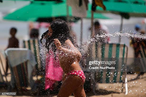 Child is seen while playing with water on Boa Viagem beach in Recife, northeast Brazil, December 03, 2016.