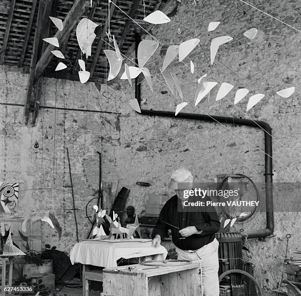 American sculptor Alexander Calder works on a new piece in his studio in Sache, France. Calder is known internationally for his unique mobiles.