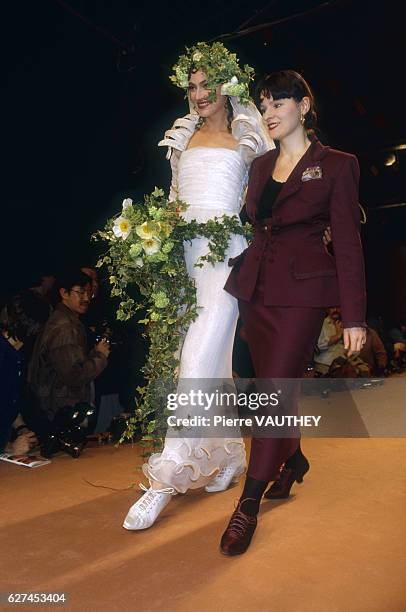 Fashion model Anne Rohart wears a ready-to-wear wedding dress by French fashion designer Lolita Lempicka as they walk down the catwalk together....