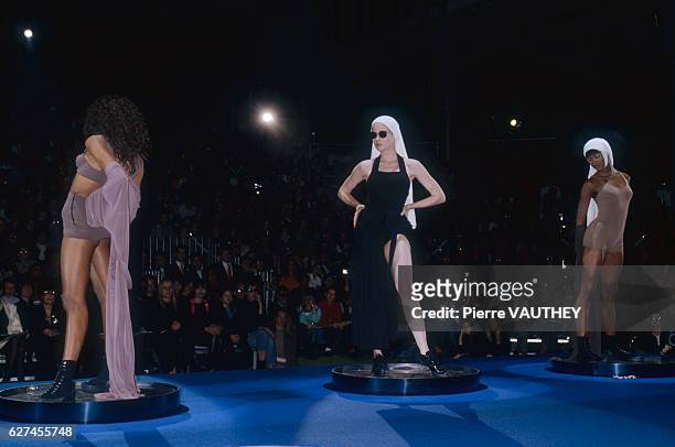 Three fashion models, including Naomi Campbell , wear ready-to-wear beach outfits by French fashion designer Jean Paul Gaultier. They modeled the...