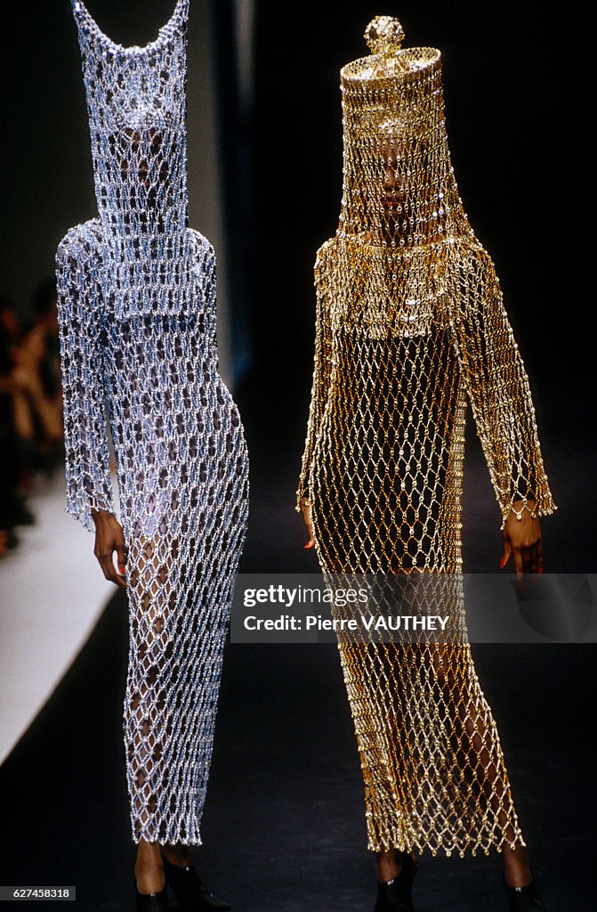Two models don haute couture body veil-like dresses at the Paco... News ...