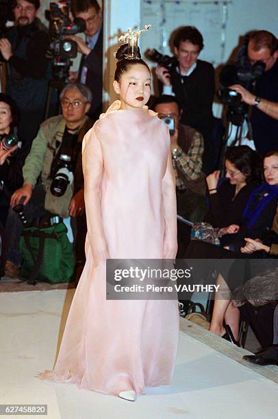 Karen Park Goude, the wife of designer Jean-Paul Goude, models a haute couture pale pink dress with hair ornament designed by French fashion designer...