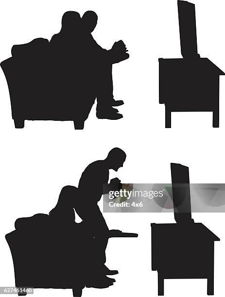 football couple watching tv - couple sitting on couch stock illustrations