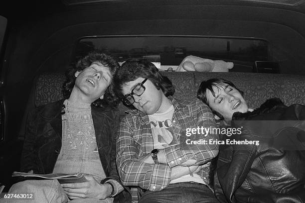 English glam rock band Mud on the back seat of a car, United Kingdom, 1975. L-R Rob Davis, Ray Stiles. Les Gray.