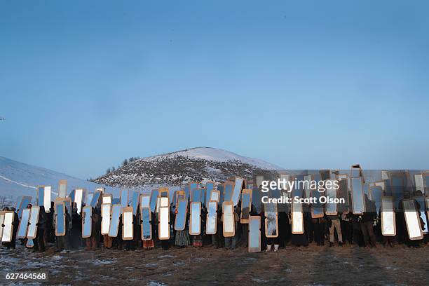 Activists participate in an art project conceived by Cannupa Hunska Luger, from the Standing Rock Sioux Tribe, at Oceti Sakowin Camp on the edge of...