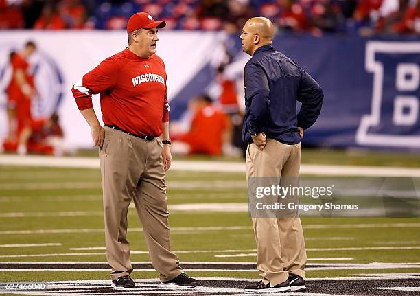 Paul Chryst, head coach of the Wisconsin Badgers, and James Franklin, head coach of the Penn State Nittany Lions, meet at midfield before the start...