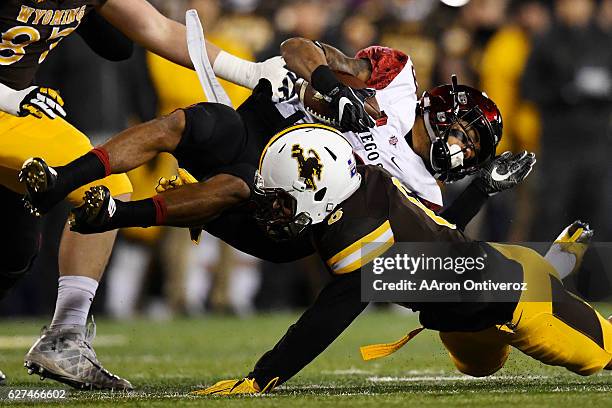 Marcus Epps of the Wyoming Cowboys stops Donnel Pumphrey of the San Diego State Aztecs during the first quarter of play on Saturday, December 3,...