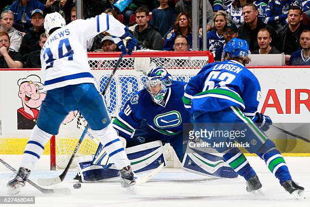 Philip Larsen watches Ryan Miller of the Vancouver Canucks make a save on Auston Matthews of the Toronto Maple Leafs during their NHL game at Rogers...