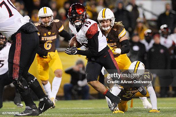 Donnel Pumphrey of the San Diego State Aztecs runs for a touchdown against the Wyoming Cowboys during the first quarter of play on Saturday, December...
