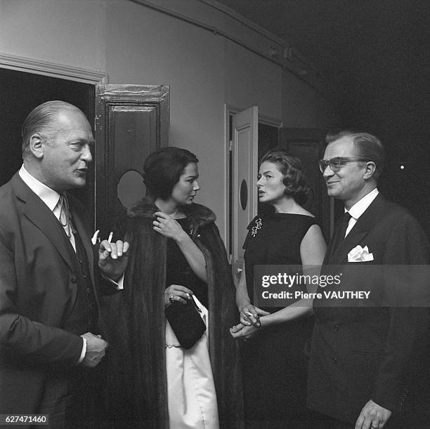 German actor Curd Jurgens, his wife Simone Bicheron, Swedish actress Ingrid Bergman and producer Lars Smith engaged in conversation.