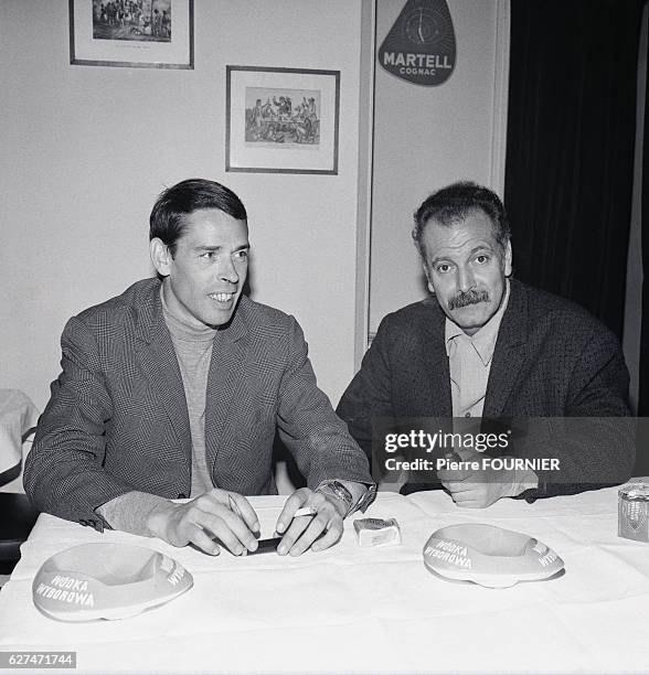 Belgian singer and songwriter Jacques Brel sits at a table with French singer and songwriter Georges Brassens. Brel enjoyed great popularity in...