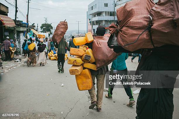 young men carry recycling goods - ethiopia city stock pictures, royalty-free photos & images