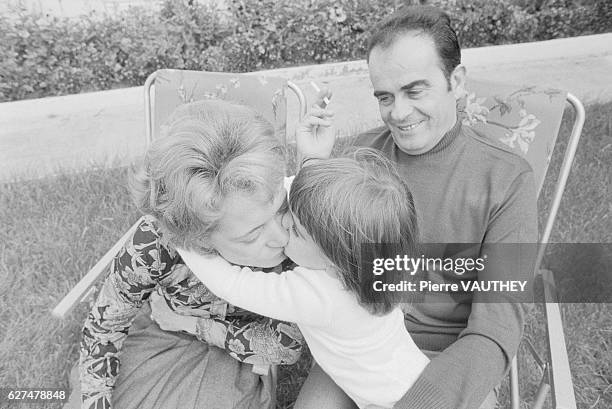 Georges Marchais, Secretary General of the French Communist Party, watches as his wife, Liliane, receives a kiss from their daughter in the backyard...