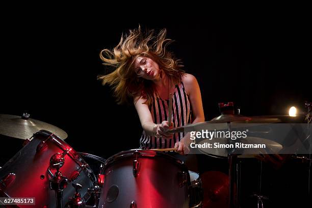 young woman plays drums with enjoyment - drum stockfoto's en -beelden