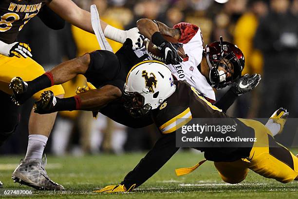 Marcus Epps of the Wyoming Cowboys stops Donnel Pumphrey of the San Diego State Aztecs during the first quarter of play on Saturday, December 3,...