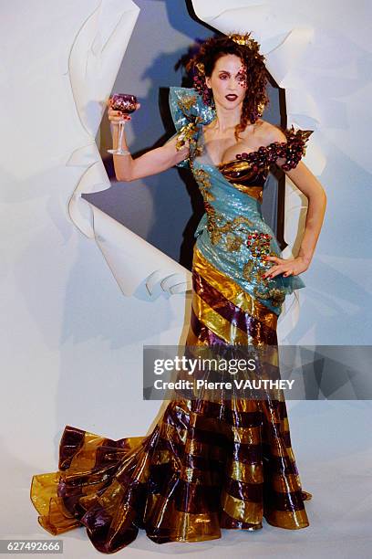 Fashion model sports a brown and golden evening gown with a light blue sash designed by John Galliano for Christian Dior at the Dior Spring-Summer...