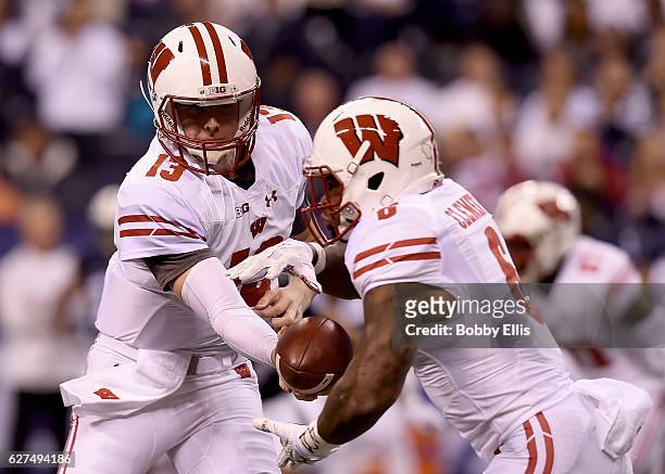 Bart Houston of the Wisconsin Badgers hands off the ball to Corey Clement of the Wisconsin Badgers during the first quarter of the Big Ten...