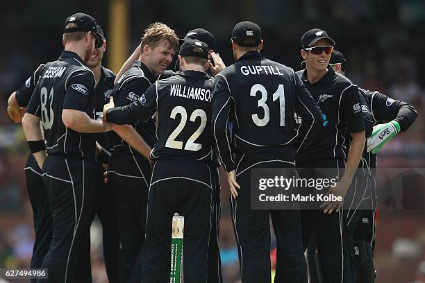 Lockie Ferguson of New Zealand celebrates with his team mates after taking the wicket of David Warner of Australia during game one of the One Day...