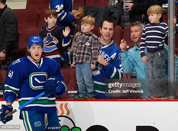 Troy Stecher of the Vancouver Canucks skates by some young Vanouver fans during their NHL game against the Toronto Maple Leafs at Rogers Arena...