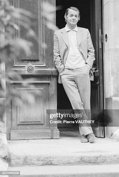 Singer and actor Serge Reggiani in the doorway at his Paris home.