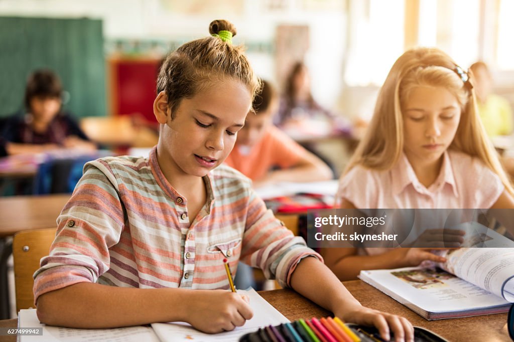 Student Class Assignment School Boy Writing An Assignment At Desk In The Classroom High-Res ...