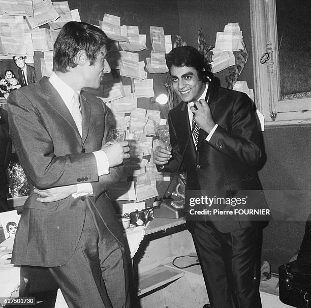 Champion French cyclist, Jacques Anquetil stops by to say hello to Enrico Macias in his dressing room at l'Olympia during his show.