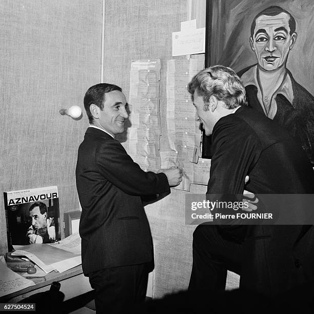 Charles Aznavour in his dressing room with Johnny Hallyday at the Olympia music hall.