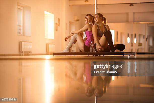 happy dancers communicating on a break in dance studio. - pole dance stock pictures, royalty-free photos & images