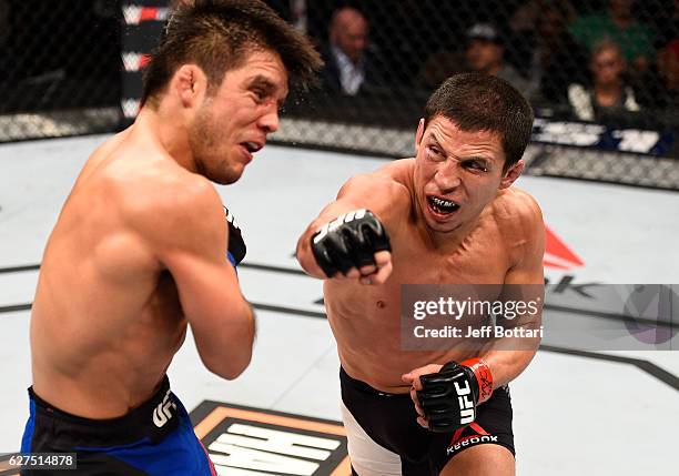 Joseph Benavidez punches Henry Cejudo in their flyweight bout during The Ultimate Fighter Finale event inside the Pearl concert theater at the Palms...