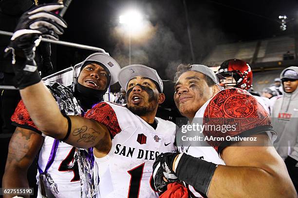 Kyahva Tezino of the San Diego State Aztecs, Donnel Pumphrey and Ronley Lakalaka celebrate after the second half of San Diego State's 27-24 win over...