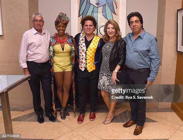 Melissa A Mitchell and Romero Britto pose with guests at Underwater Dreams To Life In Color - Art Exhibit Featuring Antonio Dominguez De Haro And...