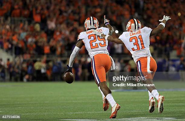 Cordrea Tankersley and Ryan Carter of the Clemson Tigers celebrate winning the ACC Championship on December 3, 2016 in Orlando, Florida.