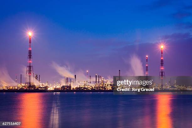 refineries at dusk - refinery stock pictures, royalty-free photos & images