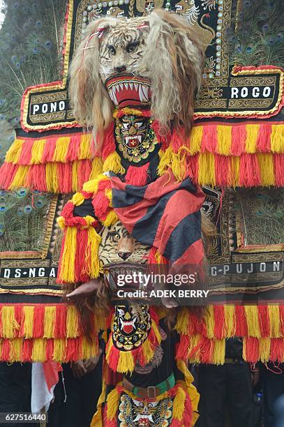 Indonesian dancers perform the Reog Ponorogo traditional dance as people attend a pro-government rally to call for unity in Jakarta on December 4,...